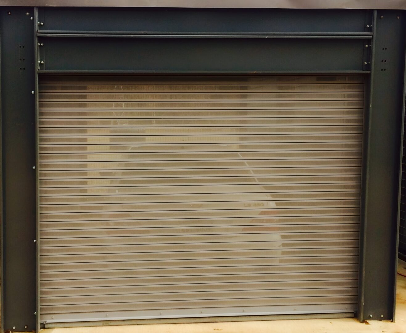 Closed metal garage door with frame.