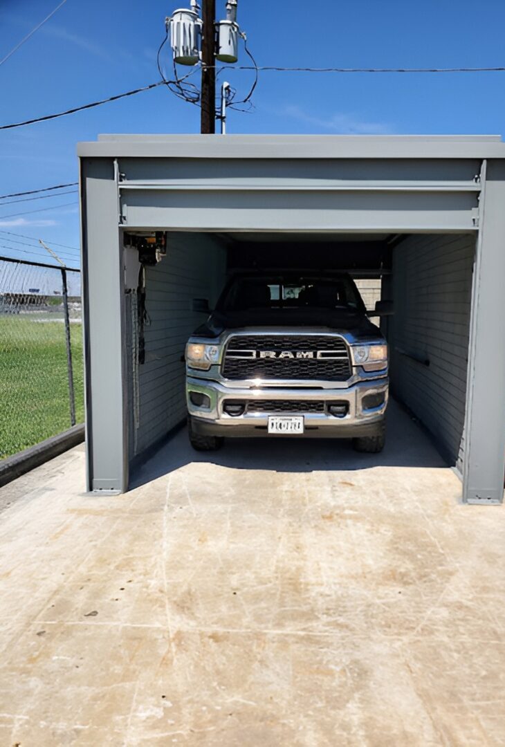 Truck parked inside a small garage.